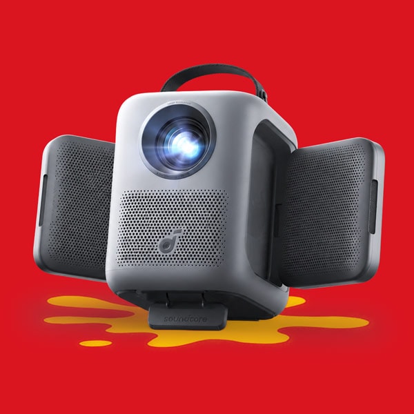Gray portable projector with side speakers extended, displayed against a red background.