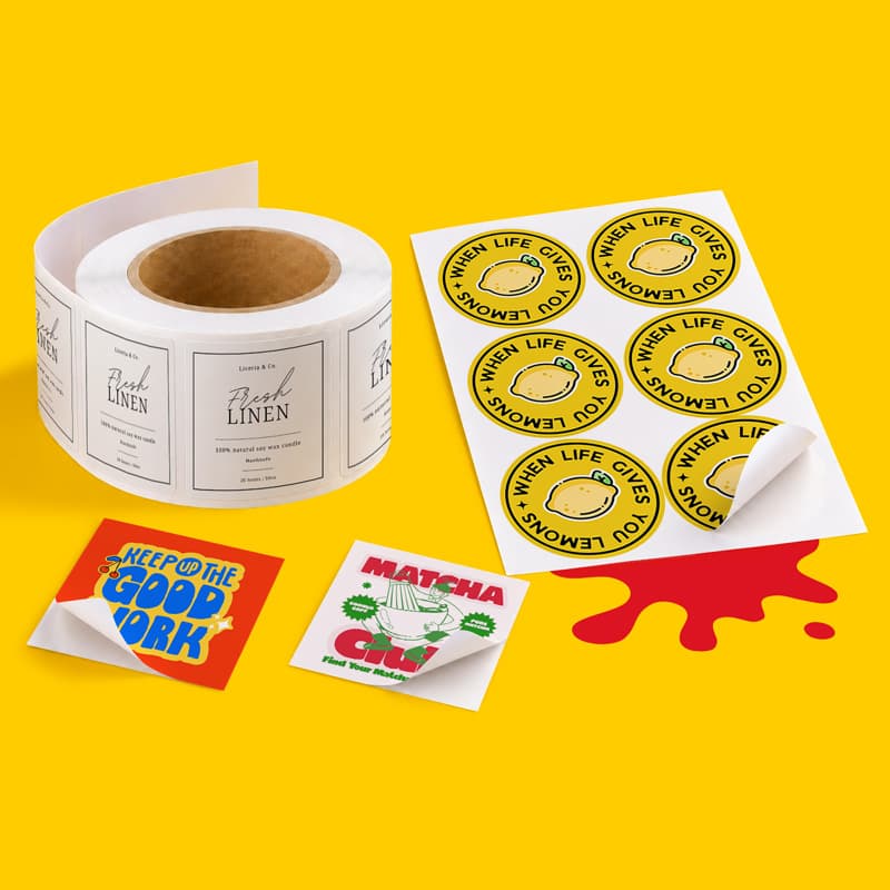 A roll of rectangular candle labels, a sheet of round lemon stickers, and two square decals.
