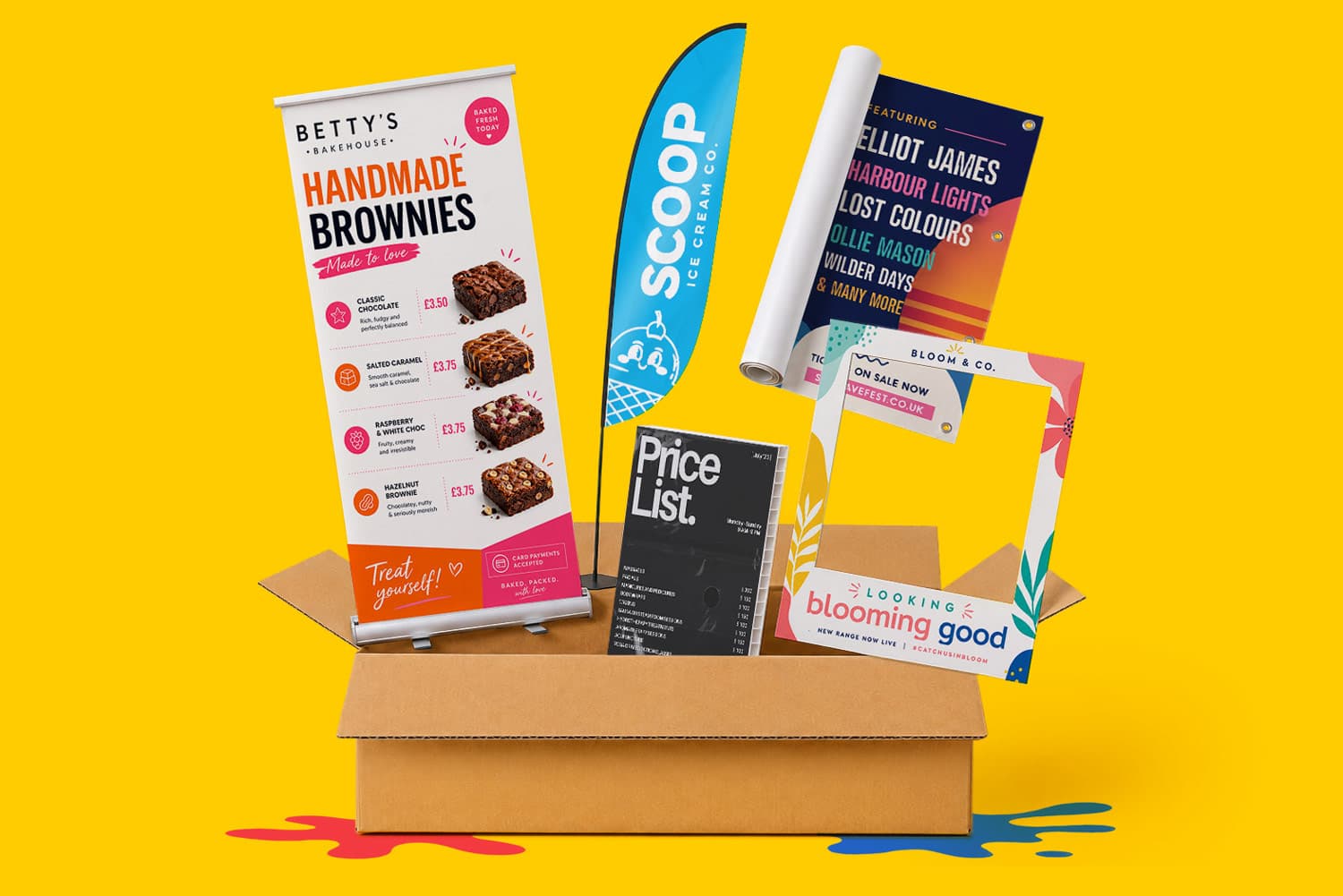A cardboard box filled with various marketing materials, including banners, posters, and a frame.