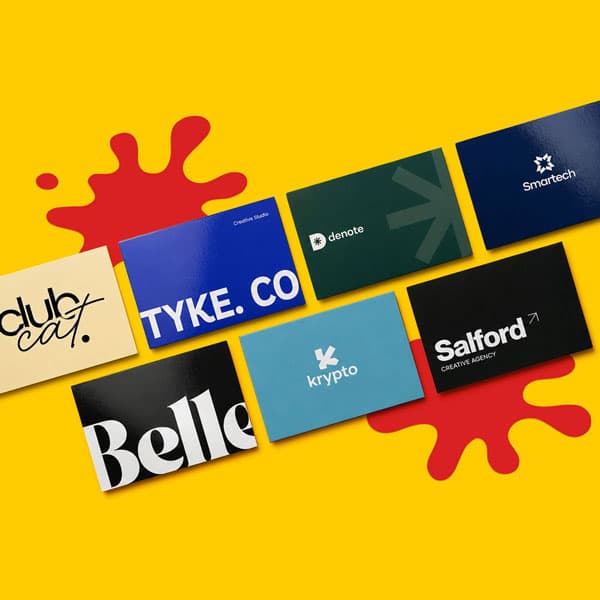 Seven colorful business cards displayed on a yellow background with red paint splatters.