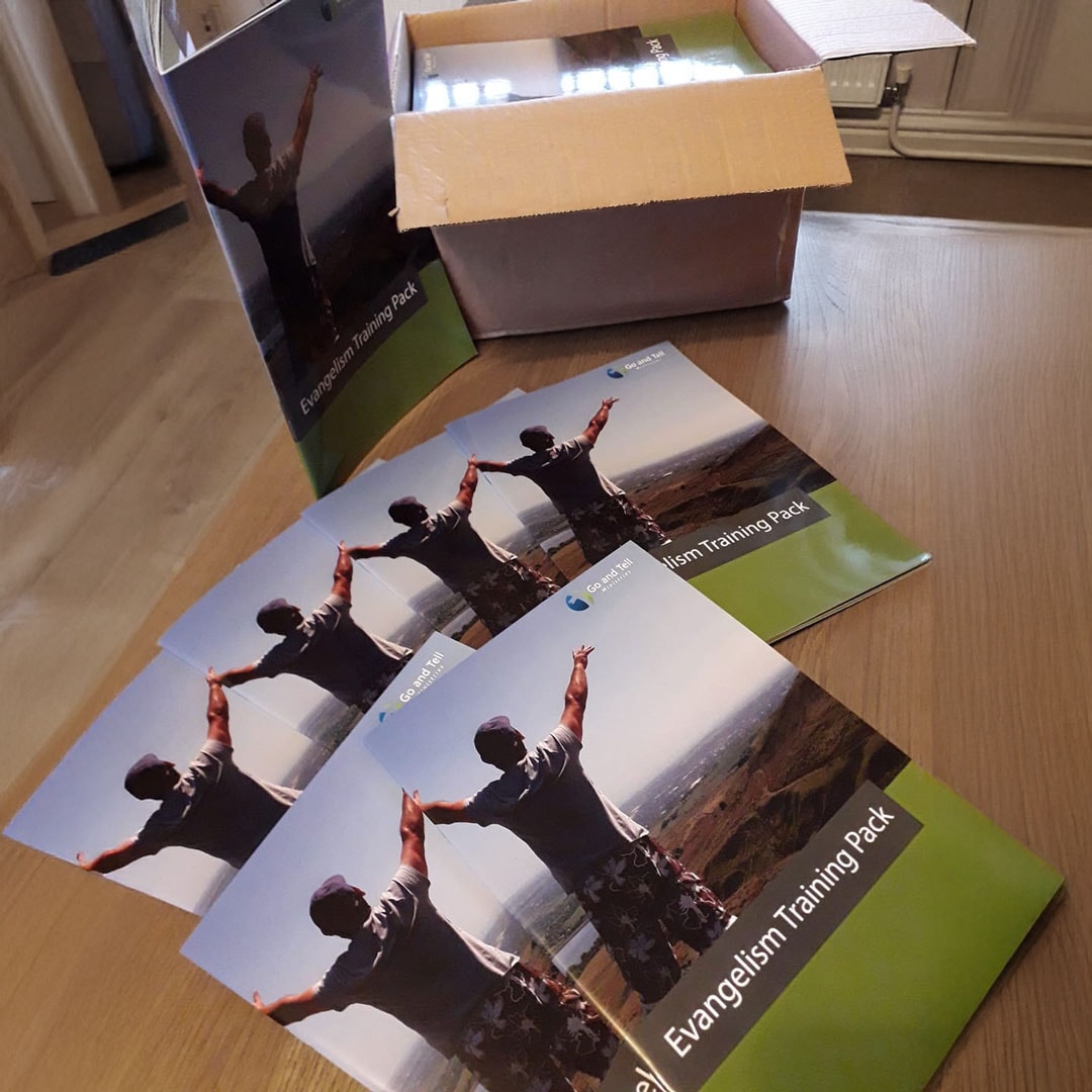 Several "Training Pack" booklets spread on a table next to an open box.