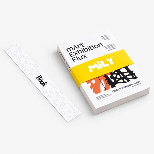 A book titled "mArt Exhibition Flux" with a yellow belly band and a white bellyband beside it.