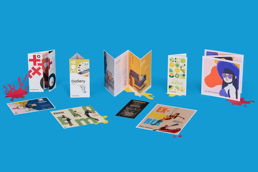 A collection of various printed brochures and cards displayed on a blue background.