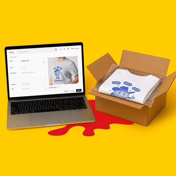 Laptop showing t-shirt listing next to an open box with a folded t-shirt on a yellow background.