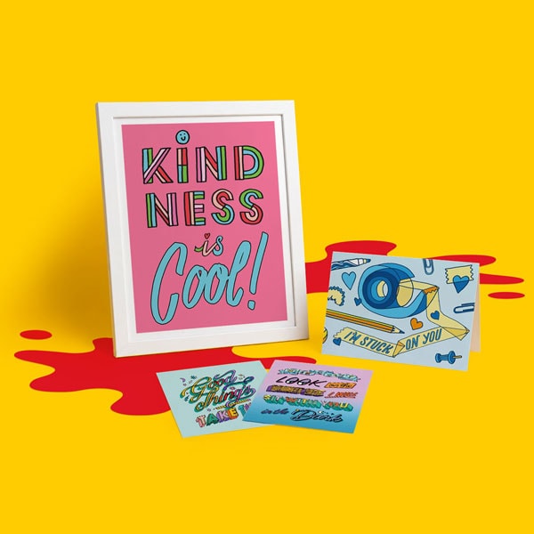 Framed “Kindness is Cool” print with three colorful postcards on a yellow background.