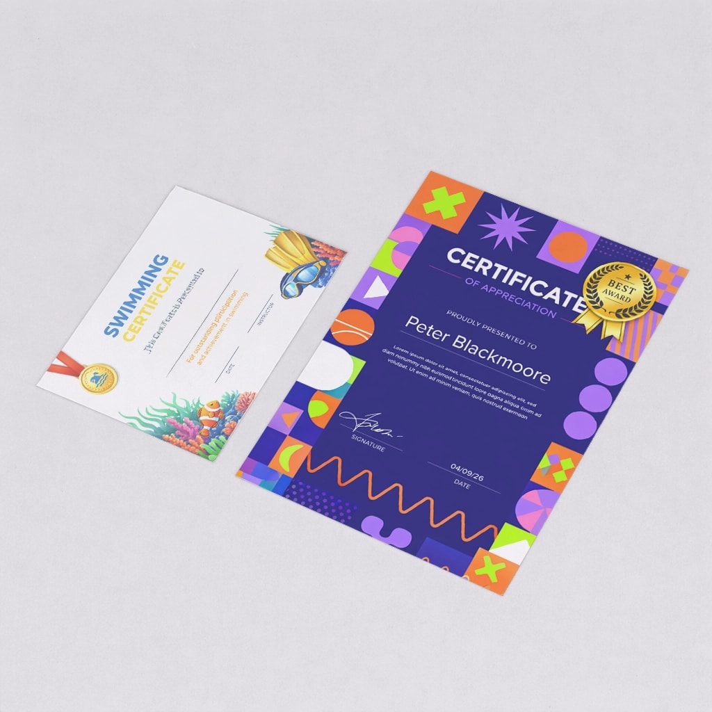 Two certificates laying on a grey surface, one for swimming and one for appreciation.