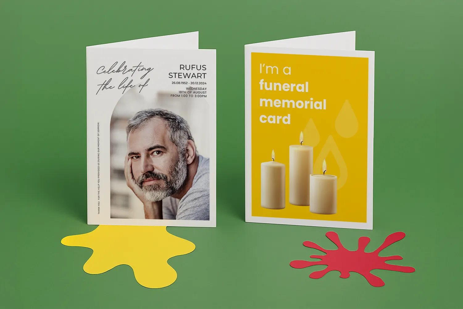 Two funeral memorial cards on a green surface with yellow and red paper shapes underneath.
