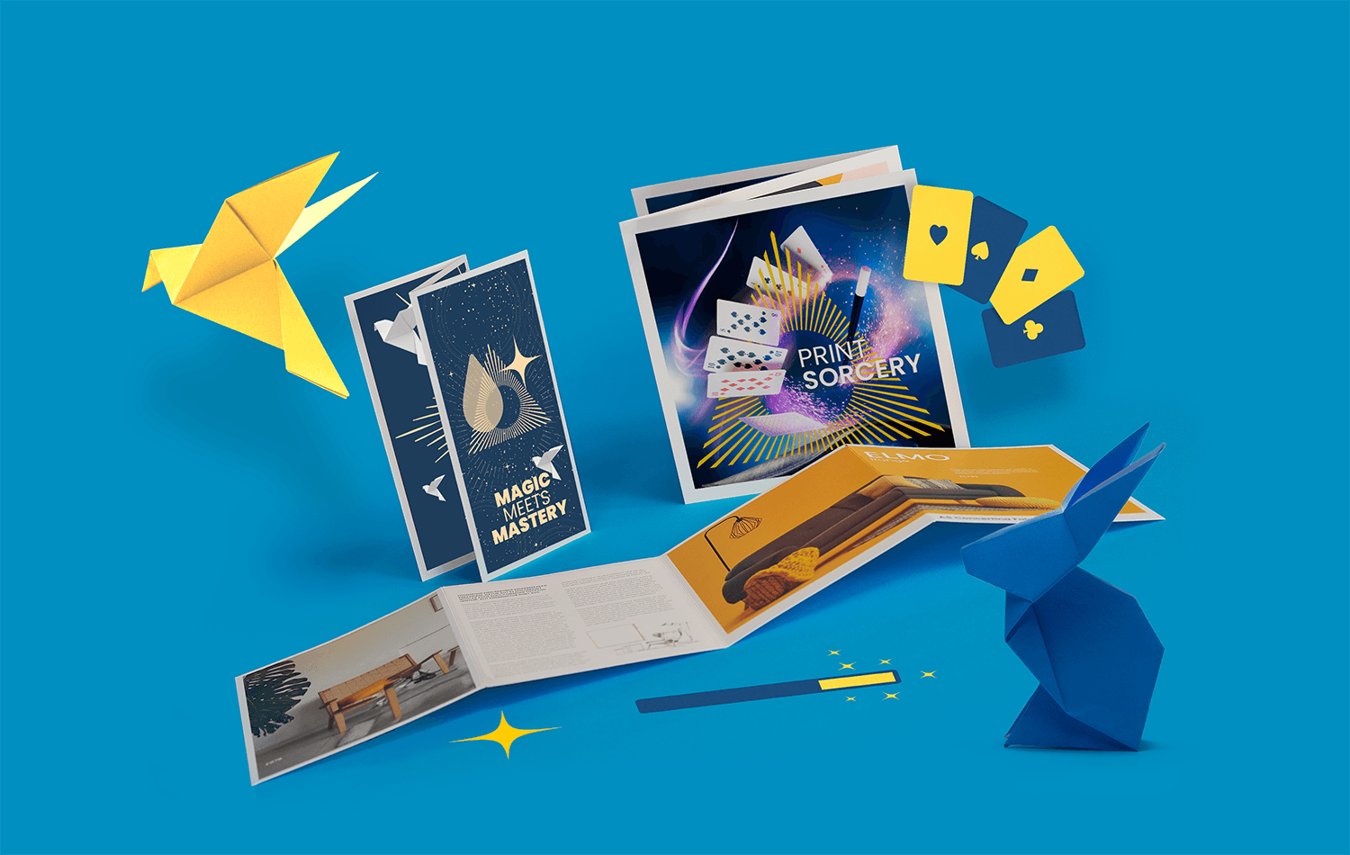 Printed brochures and flyers with cards and origami figures on a solid blue background representing WTTB's Print Sorcery.