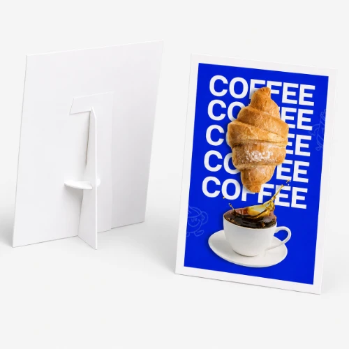Strut card with a croissant and coffee cup photo, next to a blank white card stand.