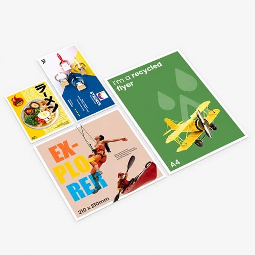 Four printed flyers of various sizes and designs arranged on a light gray surface.