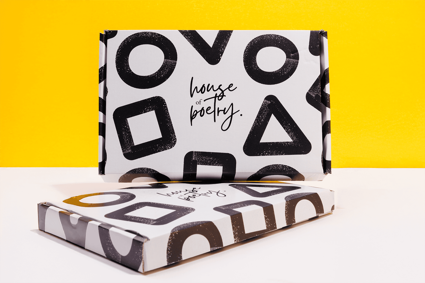 A branded gift box displayed against a vibrant yellow backdrop