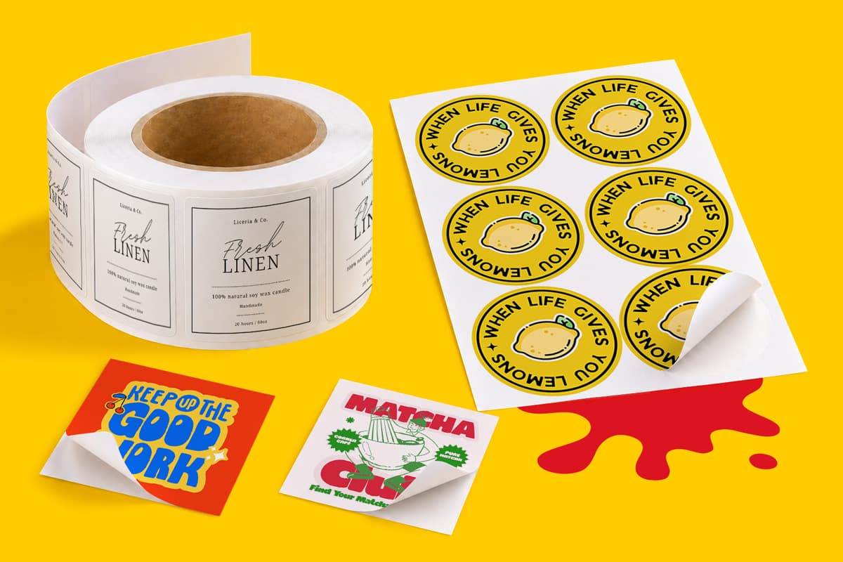 A roll of rectangular candle labels and a sheet of circular lemon-themed stickers on yellow.