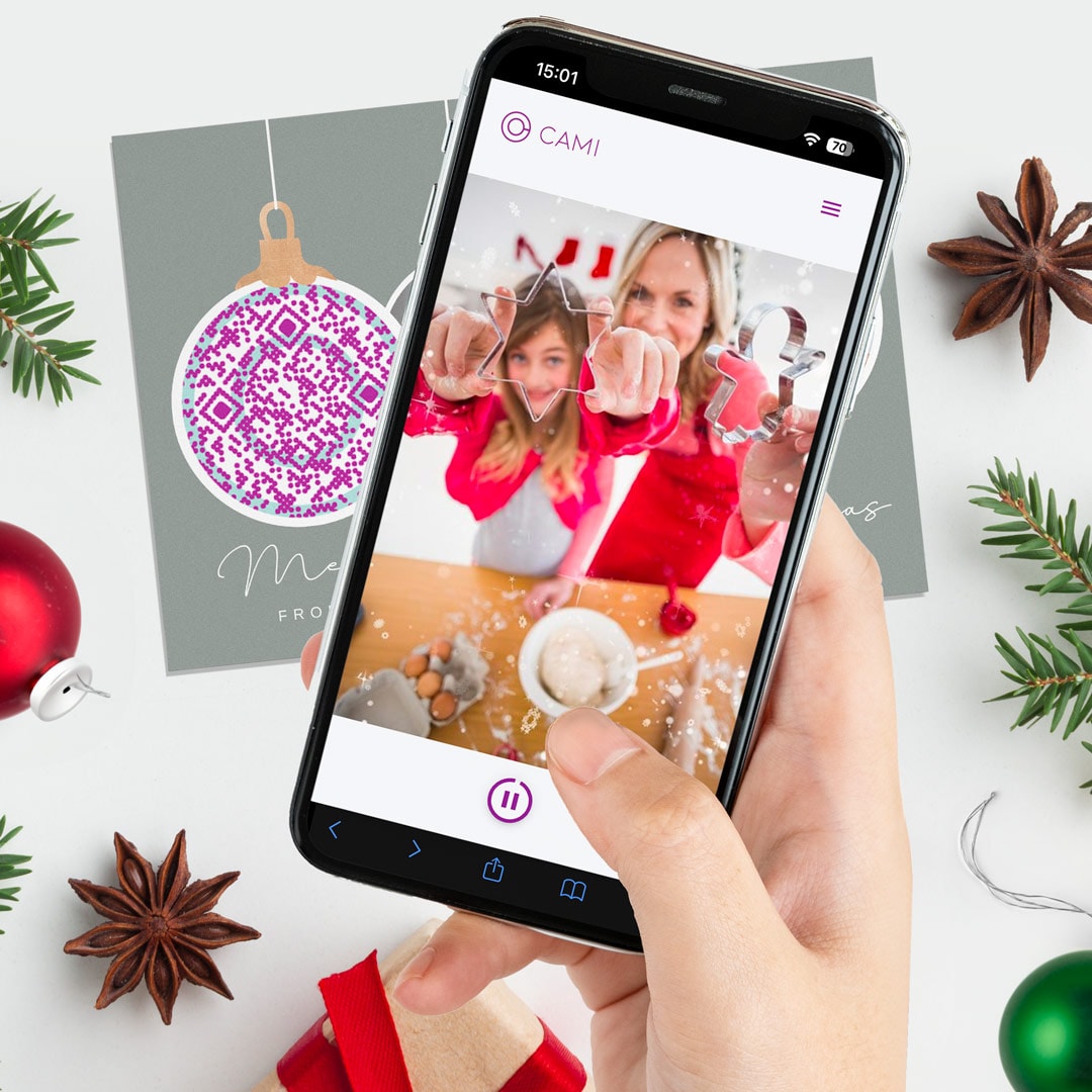 A phone scanning a video QR CAMI code showcasing a personalised baking Christmas message.