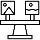 A seesaw balances two framed pictures, one with a mountain and one with waves.