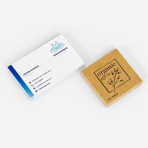Stack of business cards next to a brown stack of square business cards labeled "organic gift co.