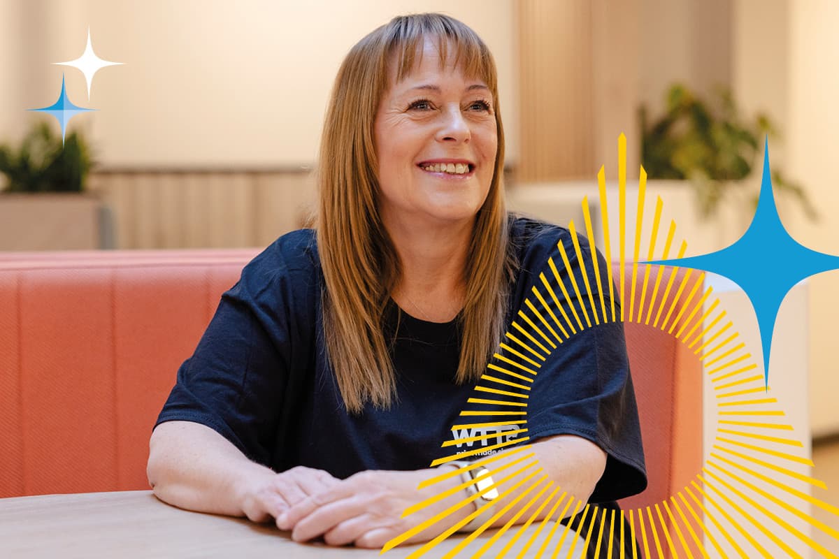 Smiling woman sitting at a table with graphic sunburst and star elements overlayed.