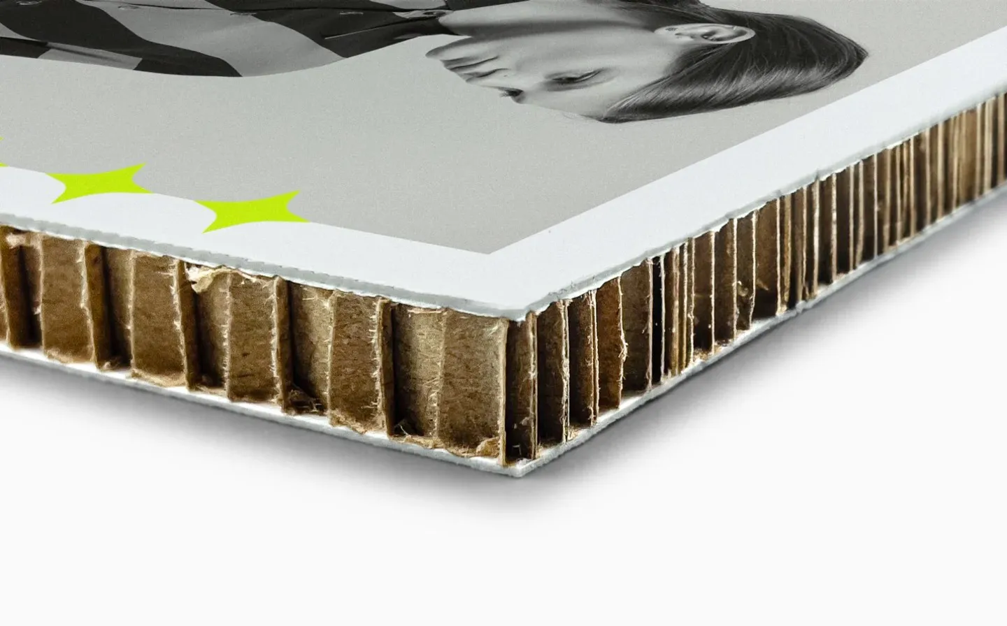 A detailed view of the corner edge of a honeycomb board, showcasing a woman in black and white