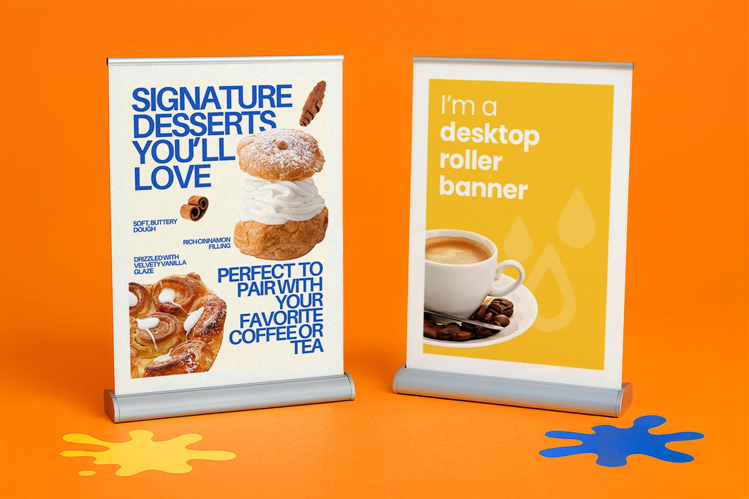 Two tabletop roller banners displaying dessert and coffee advertisements on an orange surface.