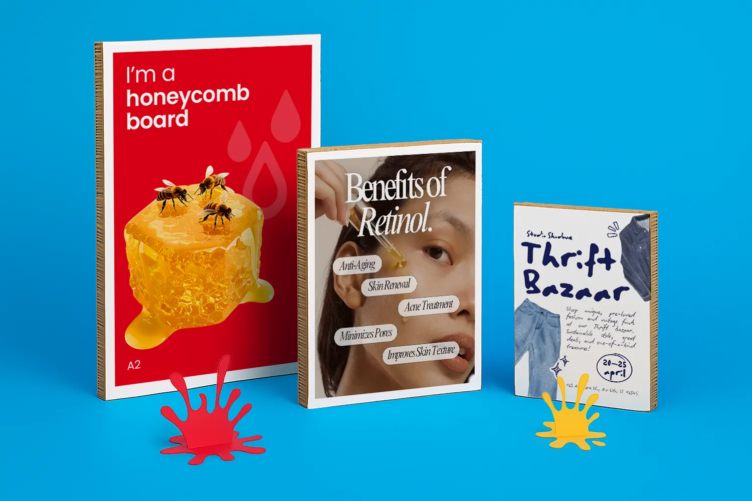 Three upright honeycomb boards with colourful, illustrated covers displayed against a bright blue background.