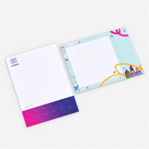 Two desk pads, one with a business design and one with a colourful, playful border.