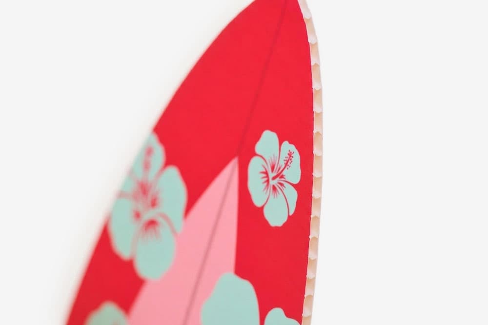 Close-up of a red object with blue floral patterns and a honeycomb-style edge.