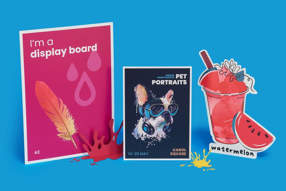 Three colourful display boards and cutout props on a bright blue background.