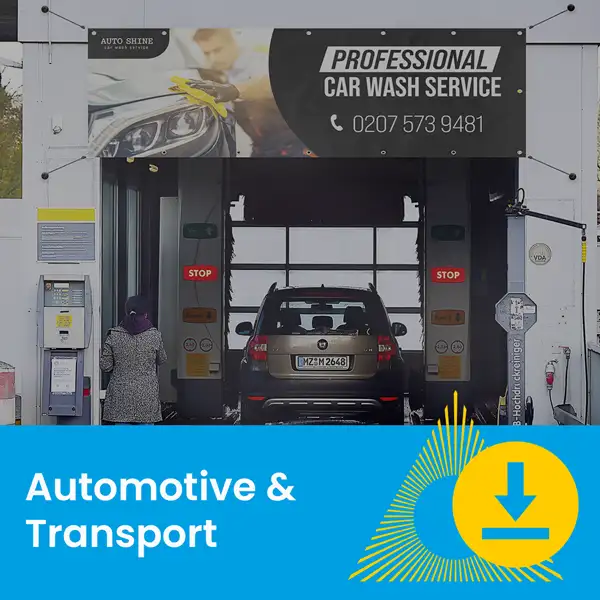 A black SUV enters an automated car wash under a sign for professional car wash services.