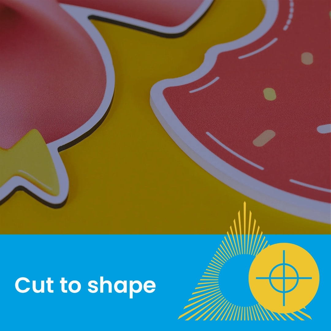 Close-up of colorful cut-out shapes on a yellow surface with text "Cut to shape" below.