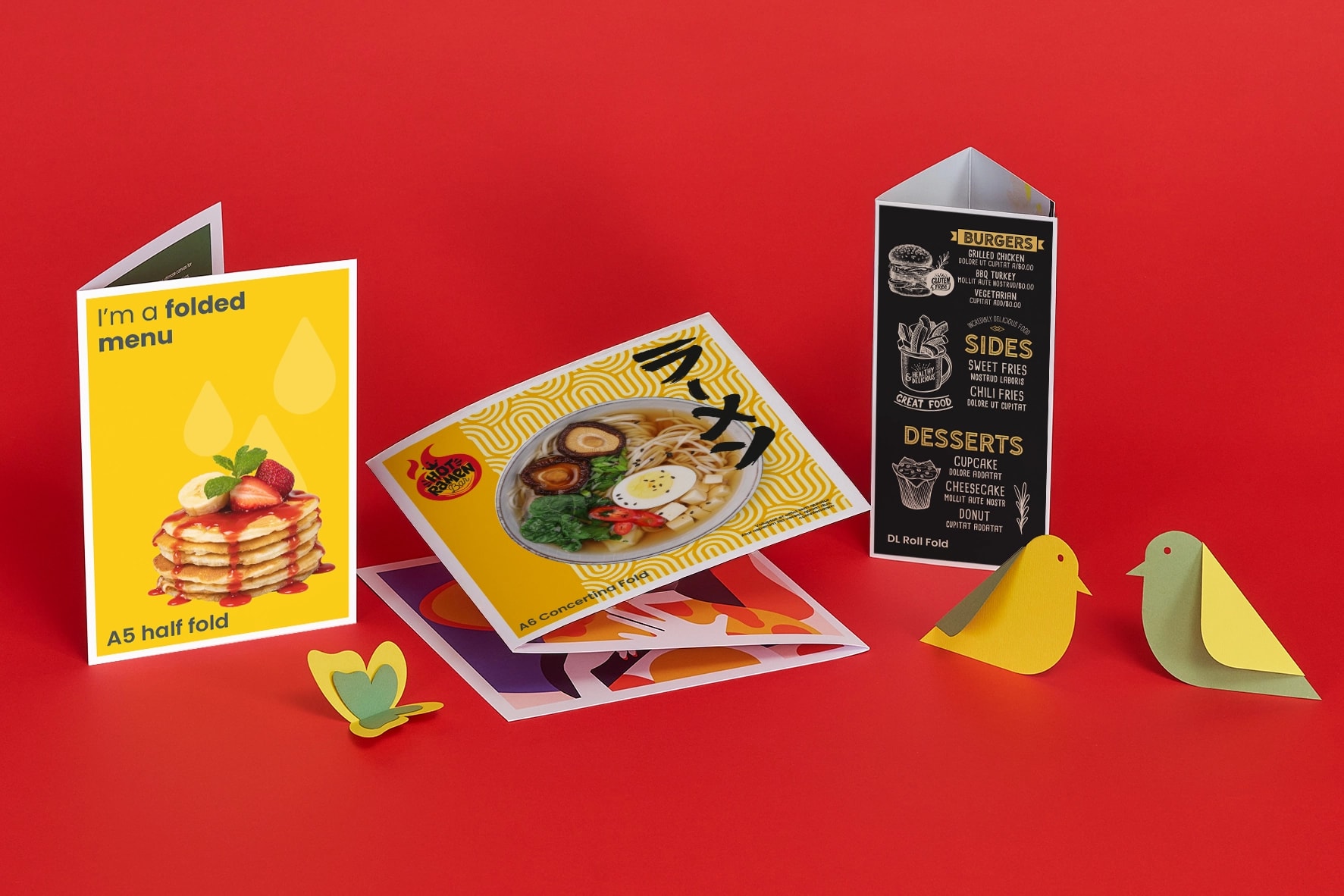 Assorted folded menus and paper birds on a red background.