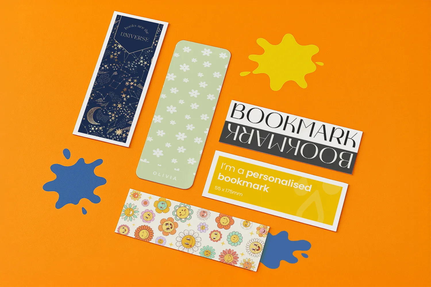 Five assorted bookmarks and two paint splatters arranged on an orange background.