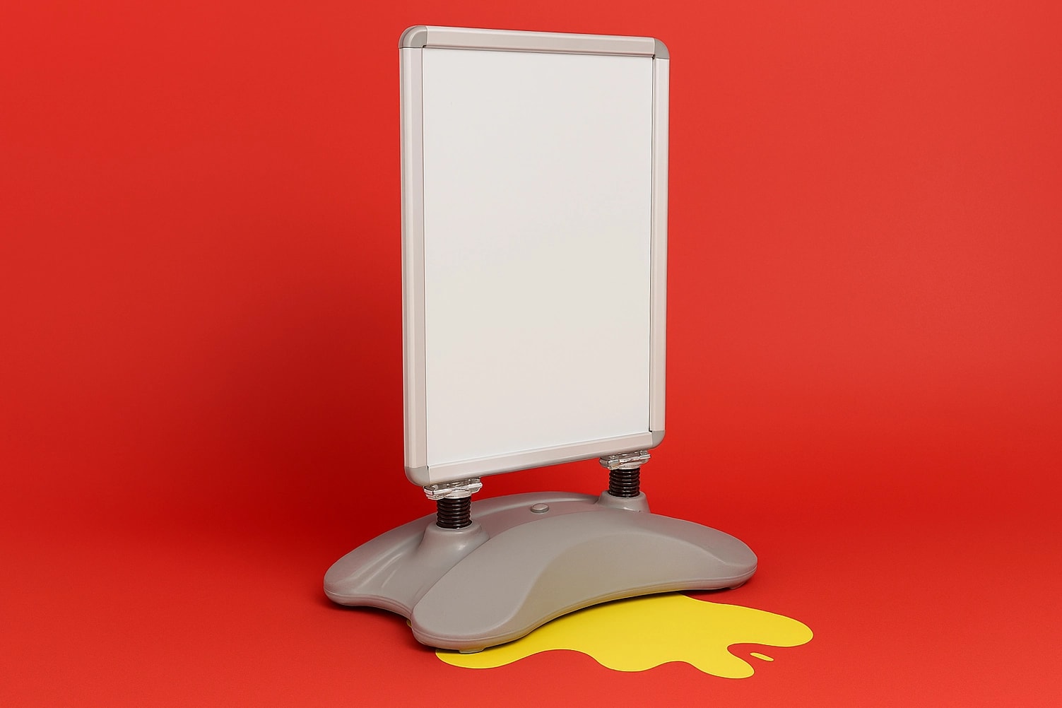 A blank whirlwind sign stands on a gray base with a yellow spill shape on a red background.