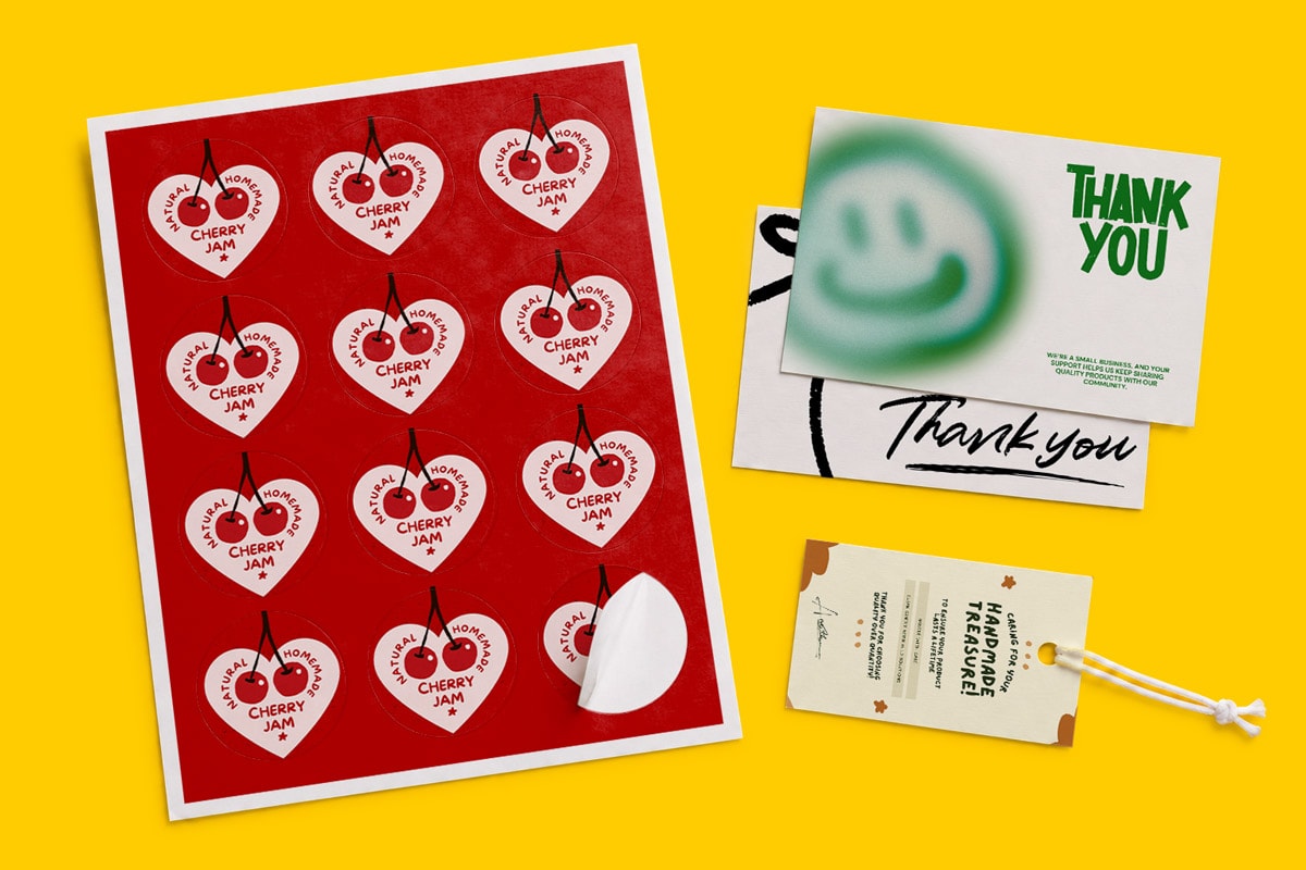 Sheet of heart-shaped cherry jam stickers and thank you cards on a yellow background.
