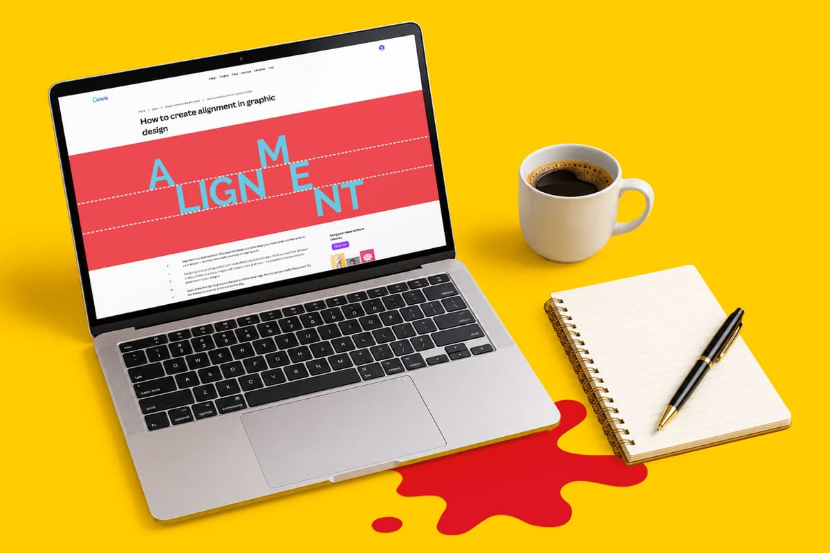 Laptop displaying a design article, next to a coffee cup, notebook, and pen on a yellow desk.