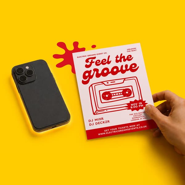 Hand holding a red event flyer next to a black smartphone on a yellow background.