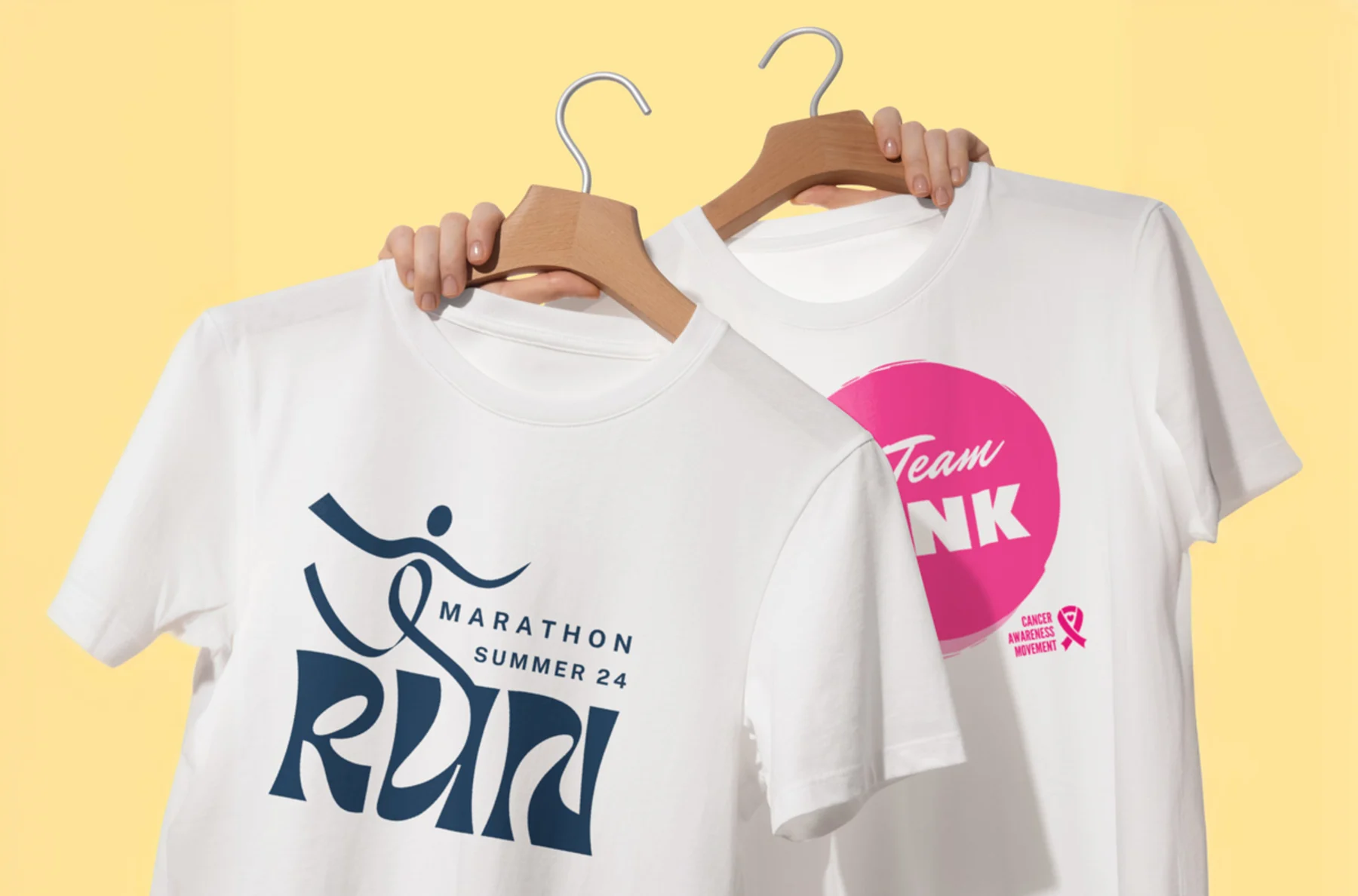 A pair of white tshirts being held up with charity phrases on a yellow background