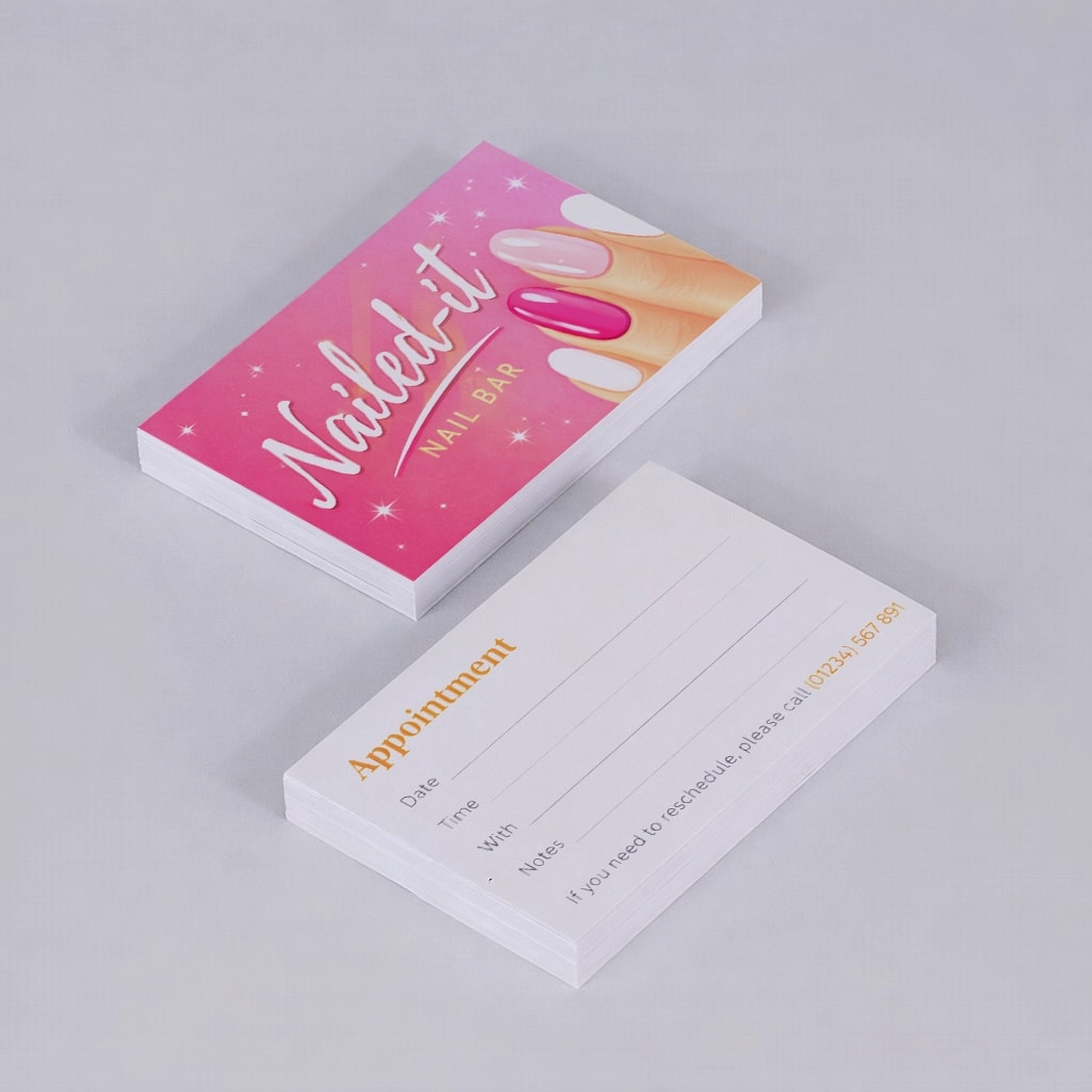 Two stacks of "Nailed it Nail Bar" appointment cards on a plain surface.