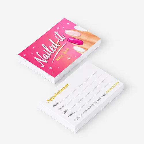 Two stacks of "Nailed it Nail Bar" appointment cards on a plain surface.