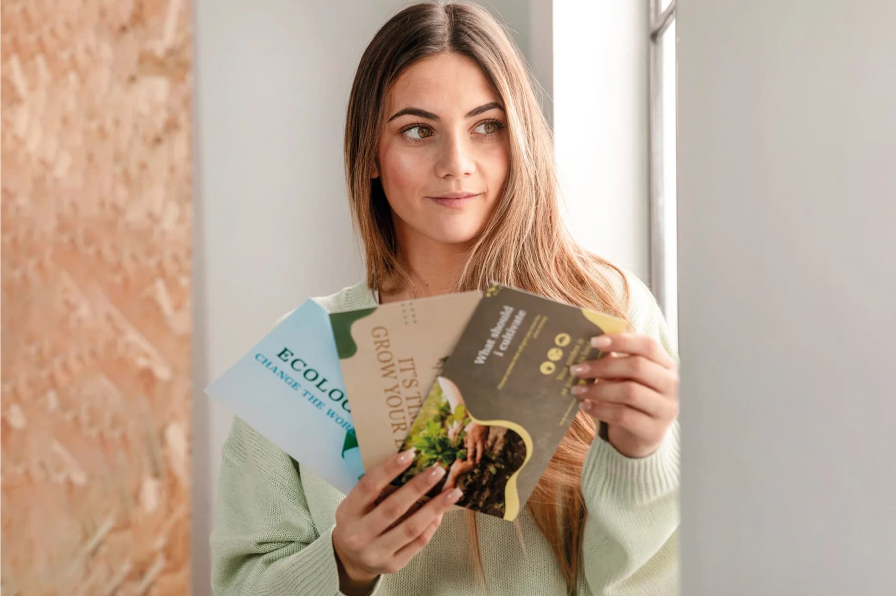 A woman proudly holds three varied cards, highlighting her choices with an engaging expression