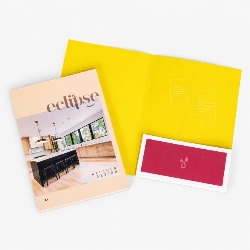Presentation folders, yellow folder, and red envelope arranged on a white surface.