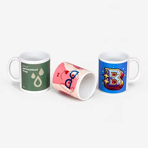 Three custom mugs with varied designs displayed on a plain background.