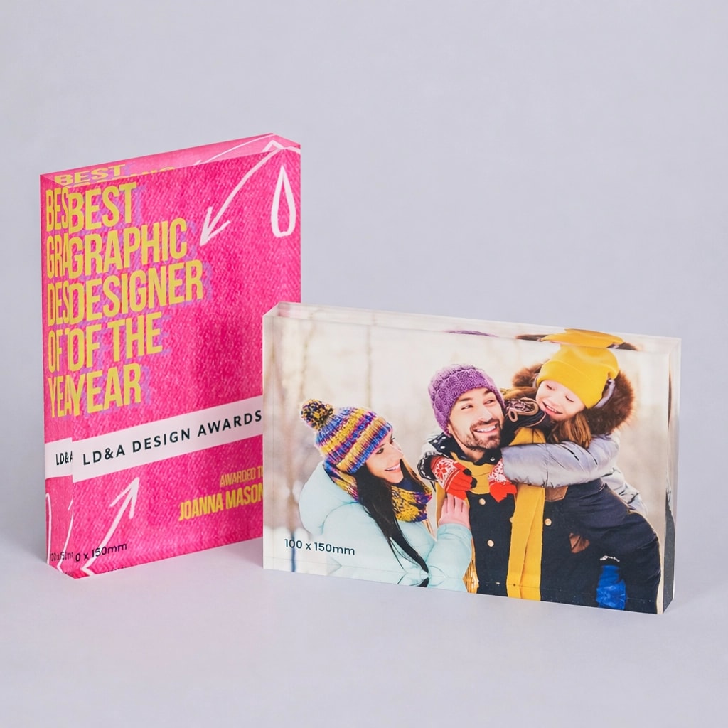 Two acrylic photo blocks: one with award text, one with a family in winter clothing.