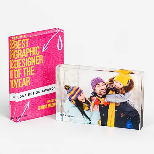 Two acrylic photo blocks: one with award text, one with a family in winter clothing.