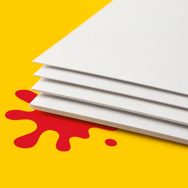 Four white sheets of paper on a yellow surface with a red paint splatter underneath.