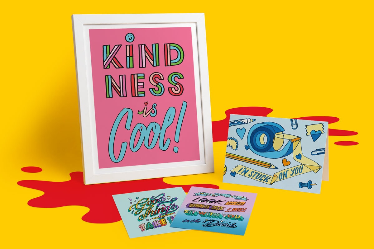 Framed "Kindness is Cool!" print with three colorful illustrated cards on a yellow background.