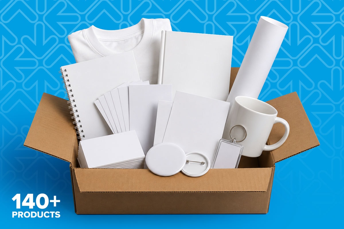 Open box with various blank items, including a mug, notebook, shirt, and cards on blue background.
