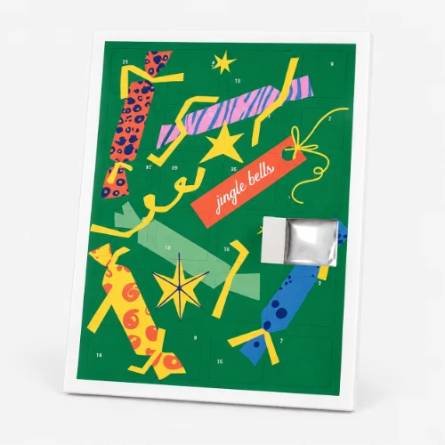 A green christmas advent calendar with colourful designs and one open door showing inside.