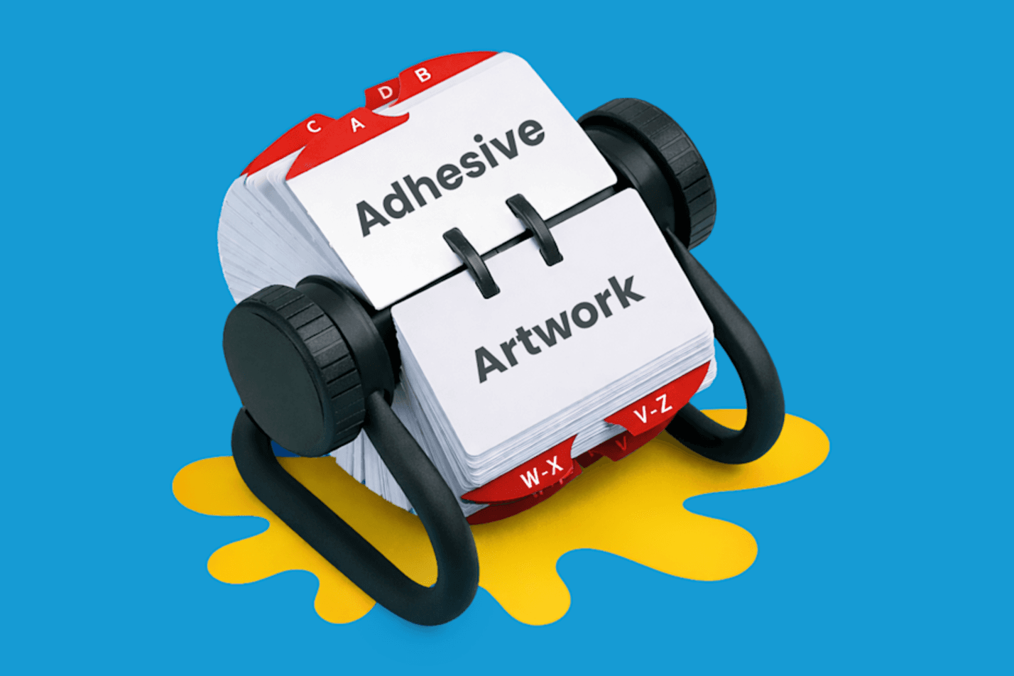 A Rolodex displaying cards labeled "Adhesive" and "Artwork" on a yellow paint splatter.