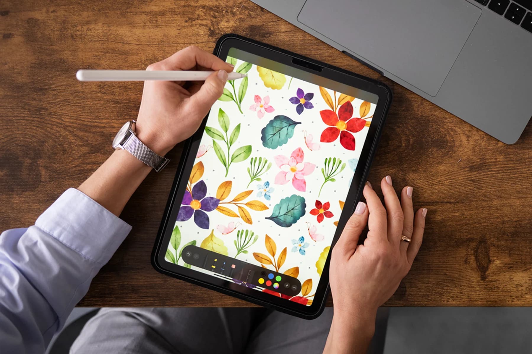 An individual engaged in design work on an iPad