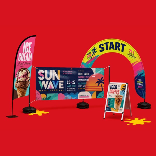 Outdoor event signs: ice cream flag, festival banner, start arch, and iced coffee board on red.