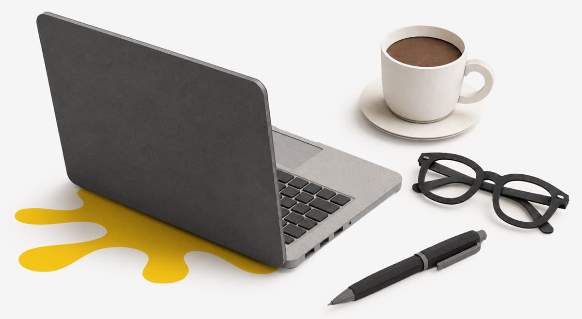 A laptop, coffee cup, eyeglasses, and pen on a desk with a yellow spill under the laptop.